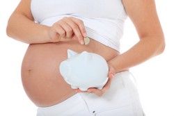 Pregnant woman puts money in piggy bank