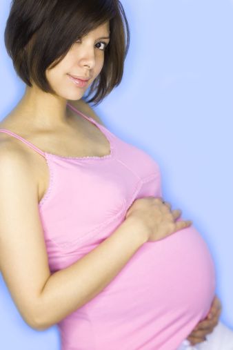 Portrait of a pregnant woman with her hand on her stomach